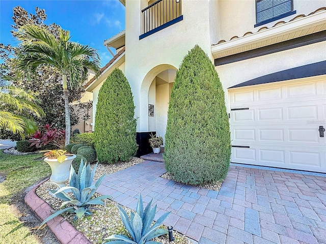 view of exterior entry featuring a garage