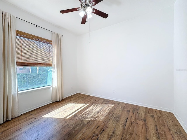 spare room featuring wood-type flooring and ceiling fan