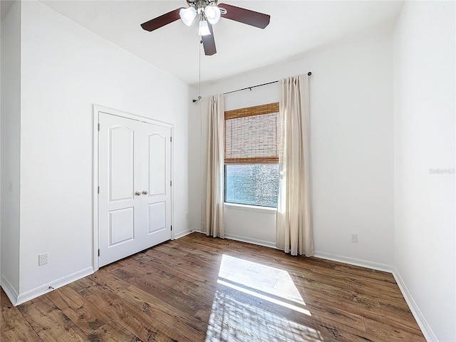 unfurnished bedroom with ceiling fan and wood-type flooring