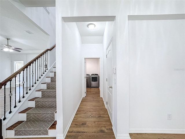 interior space with wood-type flooring and washing machine and clothes dryer