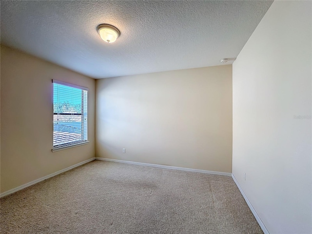 carpeted spare room featuring a textured ceiling