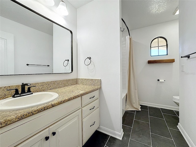 full bathroom with toilet, a textured ceiling, vanity, shower / bath combo with shower curtain, and tile patterned flooring