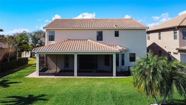 rear view of property with a sunroom and a yard