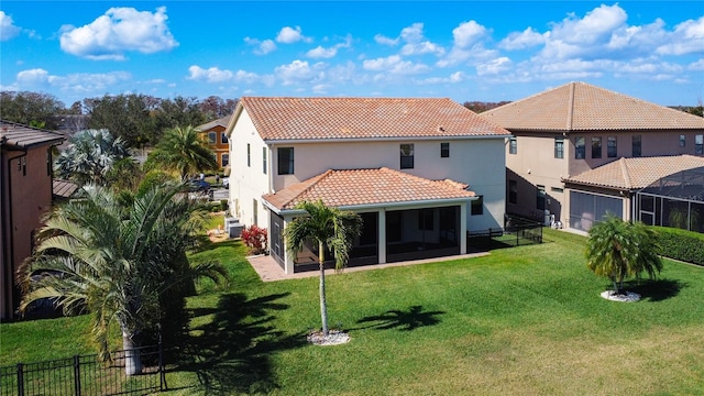 back of house featuring a yard and a sunroom