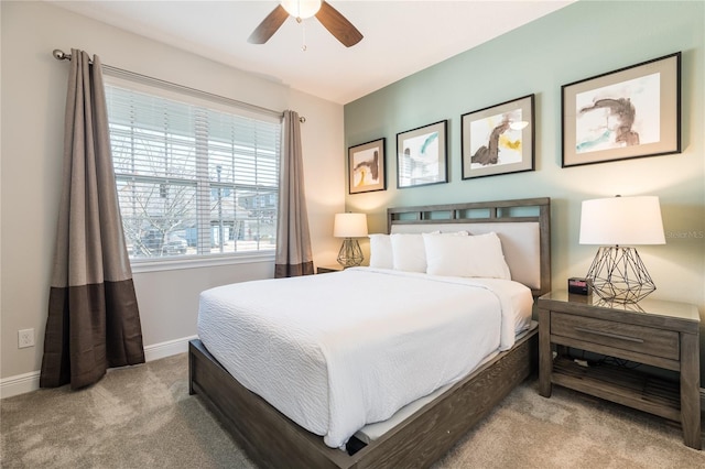 bedroom featuring light carpet and ceiling fan