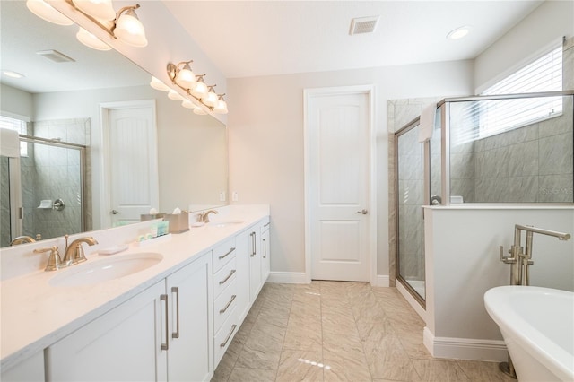 bathroom with vanity and separate shower and tub