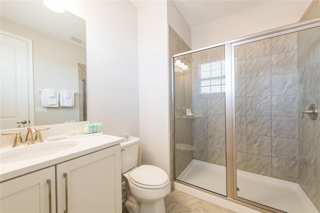 bathroom with vanity, toilet, and an enclosed shower