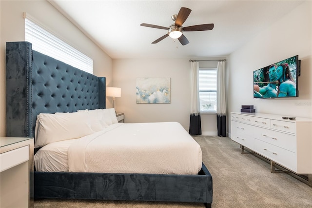 bedroom with light carpet and ceiling fan