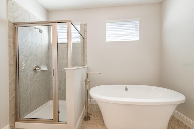 bathroom with a healthy amount of sunlight and shower with separate bathtub