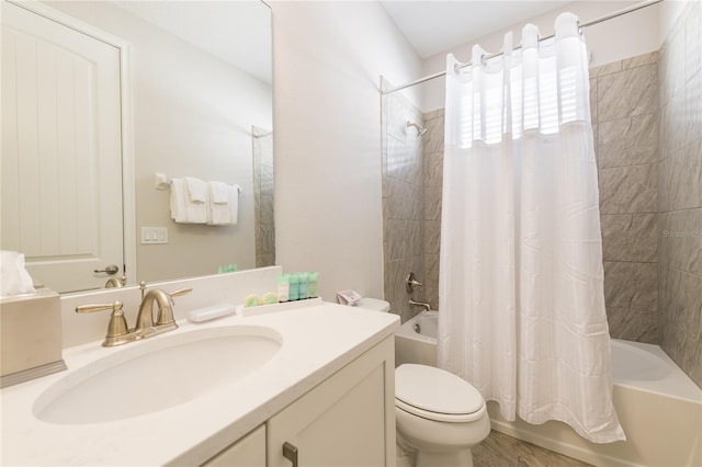 full bathroom with vanity, shower / tub combo, and toilet