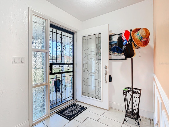 tiled foyer with a textured ceiling