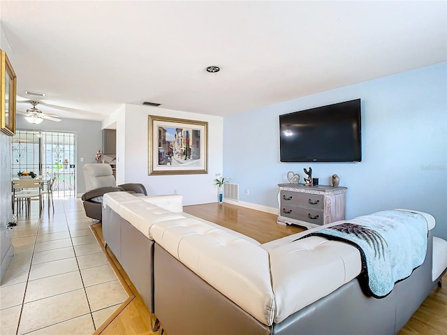 living room featuring ceiling fan and light tile patterned floors