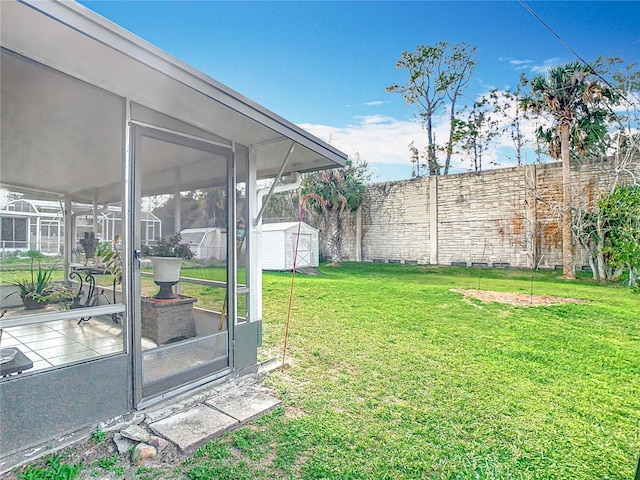 view of yard with a storage unit and a sunroom