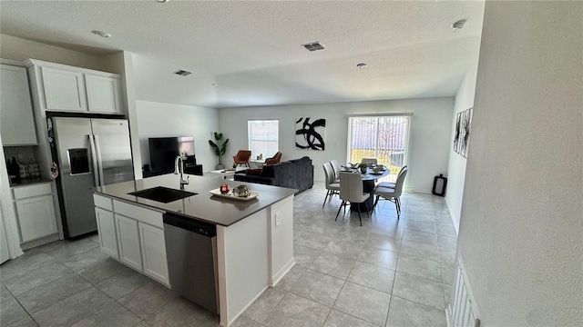 kitchen with white cabinetry, sink, a center island with sink, and appliances with stainless steel finishes