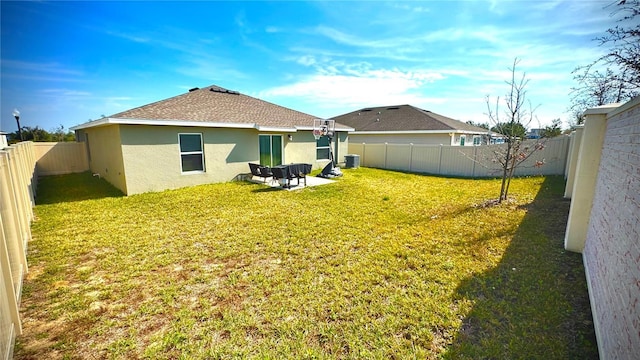 back of house with a lawn and a patio area