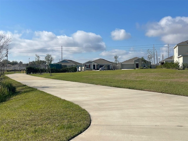 view of home's community with a yard