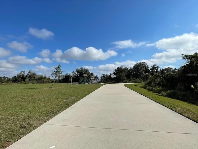 view of property's community with a lawn