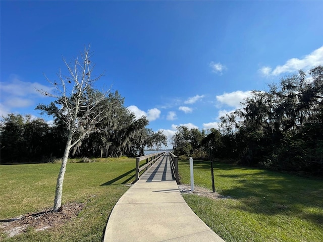 view of property's community with a lawn