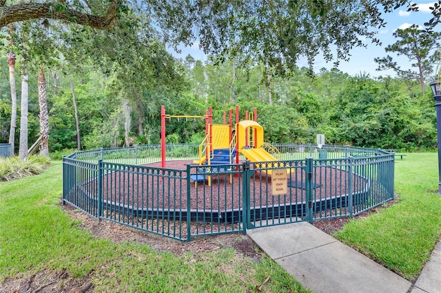 view of jungle gym featuring a lawn