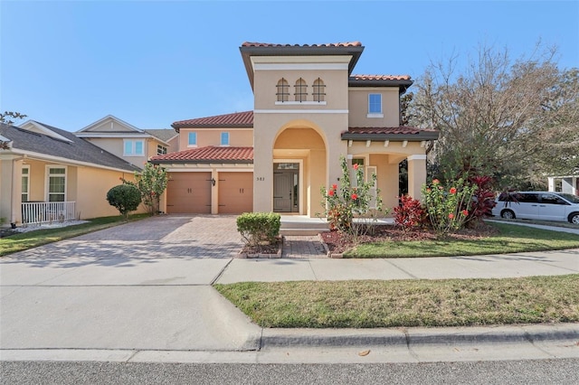 mediterranean / spanish-style home with a garage