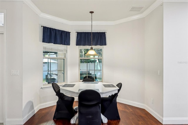 dining area with crown molding and dark hardwood / wood-style floors