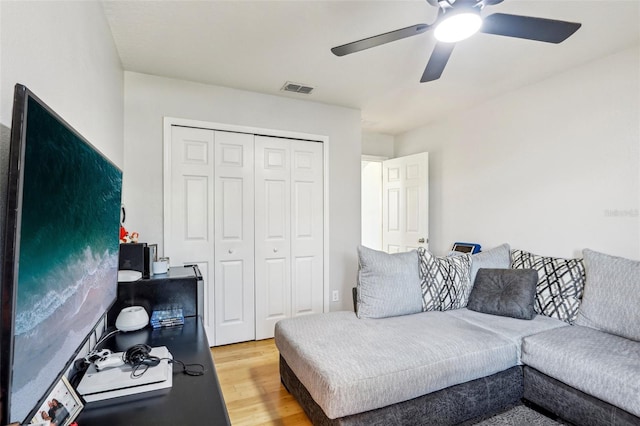 living room with ceiling fan and hardwood / wood-style floors