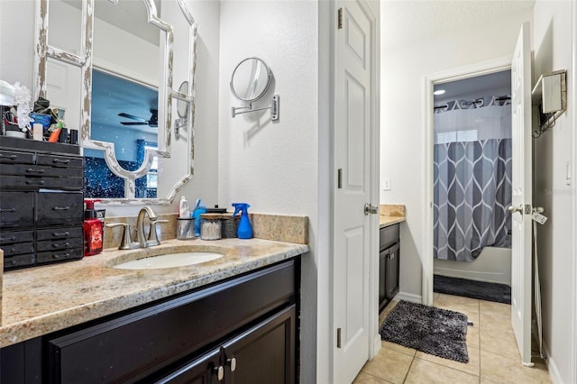 bathroom with shower / tub combo, vanity, and tile patterned flooring