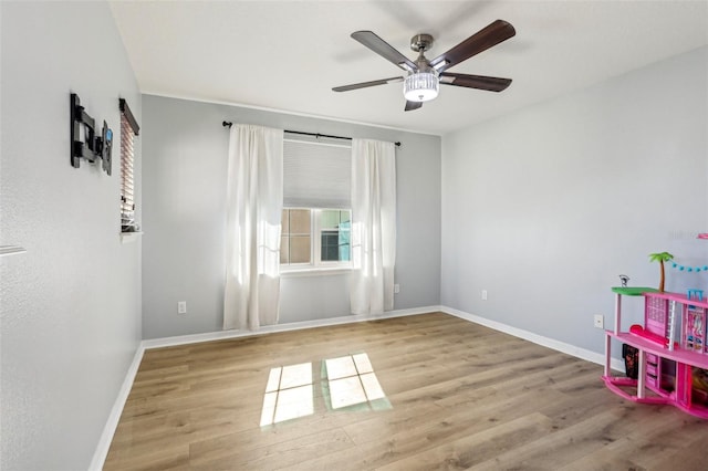 unfurnished room featuring ceiling fan and light wood-type flooring