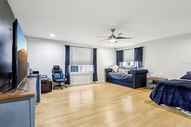 bedroom with ceiling fan and light hardwood / wood-style floors