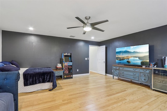 bedroom featuring wine cooler, ceiling fan, and light wood-type flooring