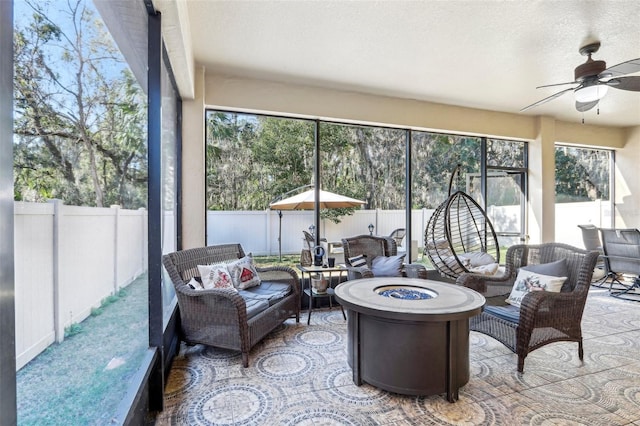 sunroom featuring ceiling fan