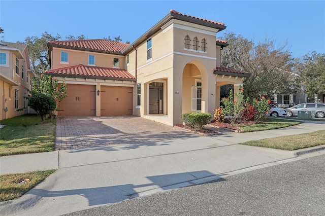 mediterranean / spanish home featuring a garage