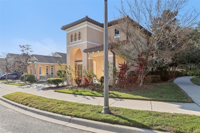 mediterranean / spanish home featuring a front yard