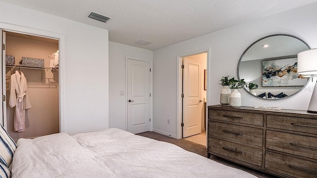 bedroom featuring light carpet and a textured ceiling