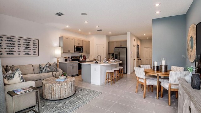 tiled living room featuring sink