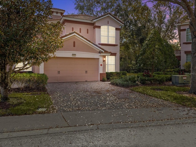 view of front of home with cooling unit and a garage