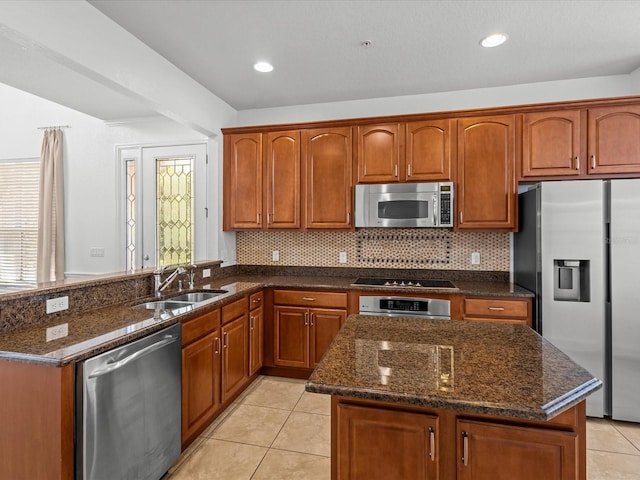 1431 Milledge Ln, Davenport, FL 33896 - kitchen featuring sink, tasteful backsplash, light tile patterned floors, dark stone counters, and stainless steel appliances