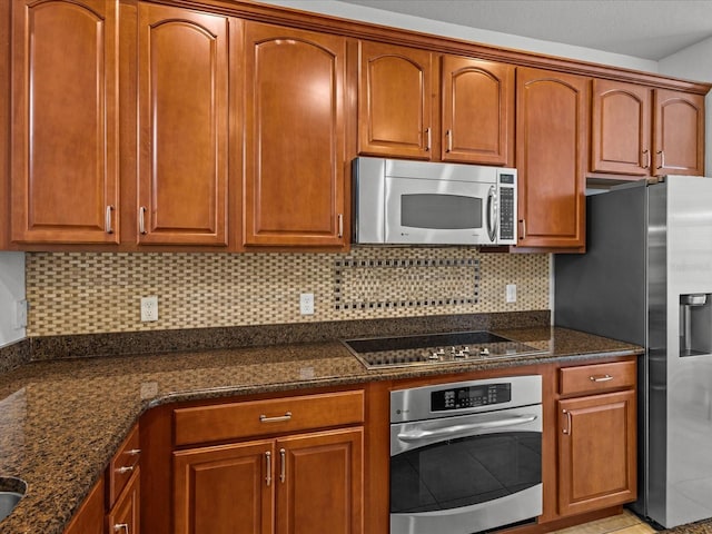 1431 Milledge Ln, Davenport, FL 33896 - kitchen with stainless steel appliances, backsplash, and dark stone counters