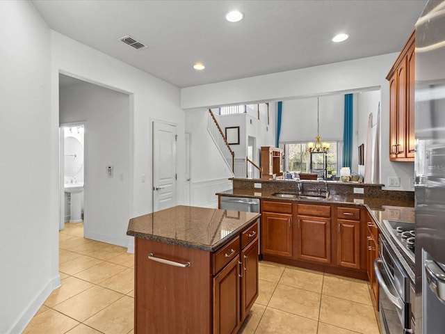 1431 Milledge Ln, Davenport, FL 33896 - kitchen with sink, a kitchen island, stainless steel appliances, light tile patterned flooring, and a chandelier