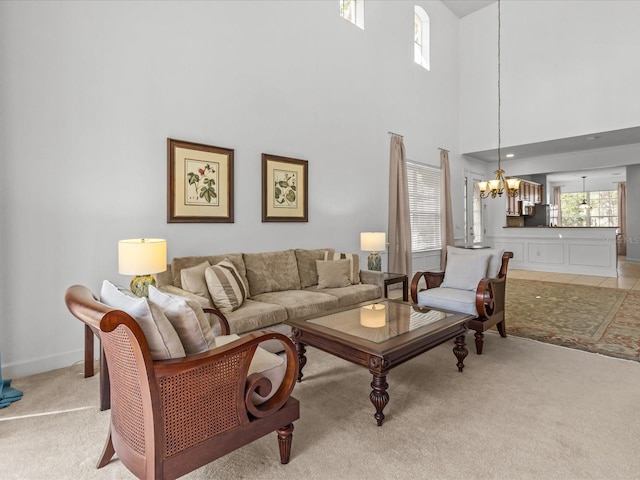 1431 Milledge Ln, Davenport, FL 33896 - living room with light colored carpet, a towering ceiling, and a notable chandelier