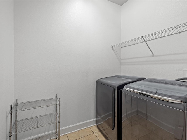 1431 Milledge Ln, Davenport, FL 33896 - washroom with light tile patterned floors and independent washer and dryer