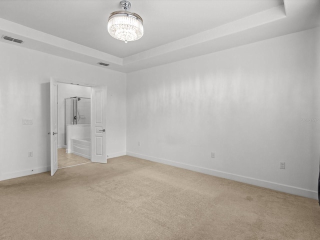 1431 Milledge Ln, Davenport, FL 33896 - unfurnished room with an inviting chandelier, a tray ceiling, and light carpet