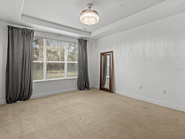 1431 Milledge Ln, Davenport, FL 33896 - unfurnished room featuring a raised ceiling, light colored carpet, and a notable chandelier