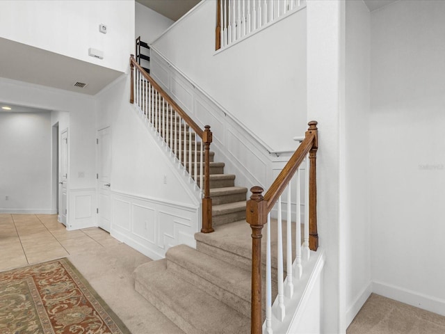 1431 Milledge Ln, Davenport, FL 33896 - staircase featuring a towering ceiling and carpet flooring