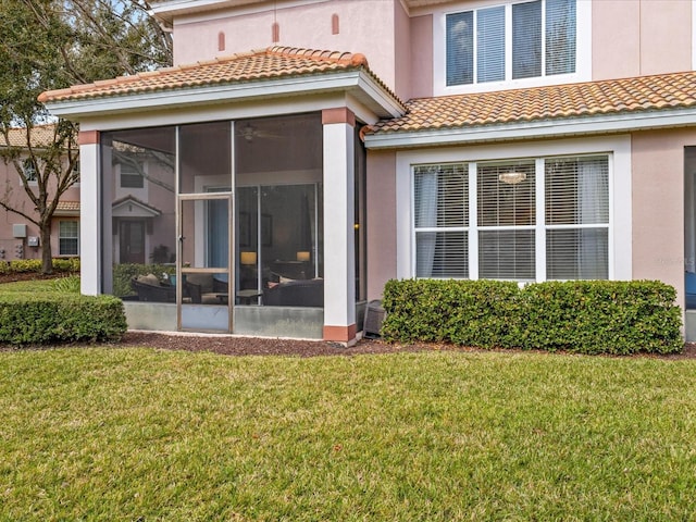 1431 Milledge Ln, Davenport, FL 33896 - rear view of house featuring a lawn and a sunroom