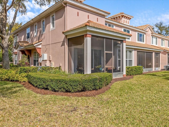 1431 Milledge Ln, Davenport, FL 33896 - back of house with a lawn and a sunroom