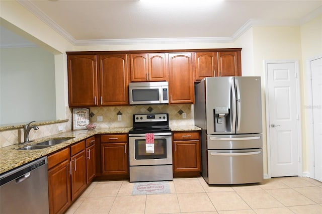 kitchen featuring sink, appliances with stainless steel finishes, light stone countertops, and decorative backsplash