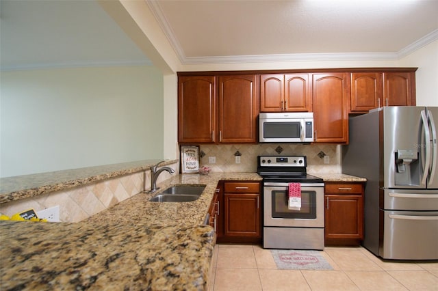 kitchen with appliances with stainless steel finishes, sink, and light stone countertops
