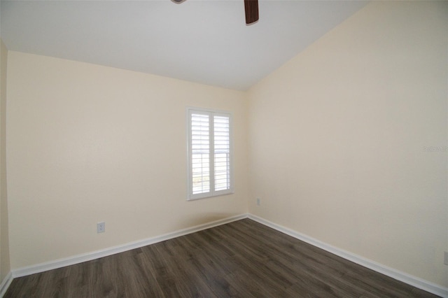 empty room featuring vaulted ceiling and dark wood-type flooring