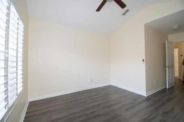 empty room featuring vaulted ceiling, ceiling fan, and dark hardwood / wood-style floors